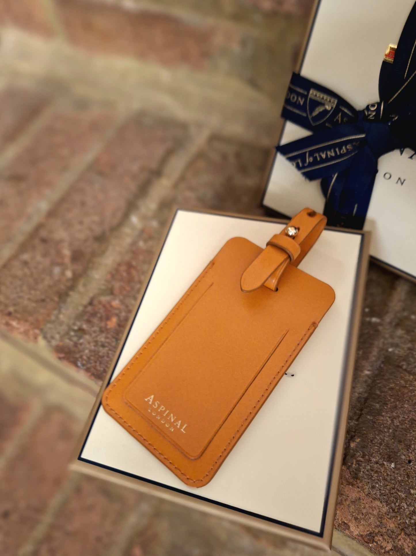 Aspinal tan luggage tag